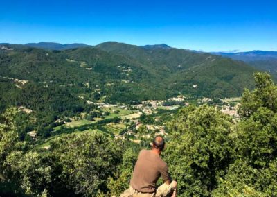 Homme assis sur un rocher surplombant saint Jean du Gard